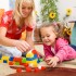 depositphotos_7180375-Teacher-and-child-are-playing-with-bricks.jpg